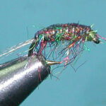 Dark Scud fly in a fly tying vise